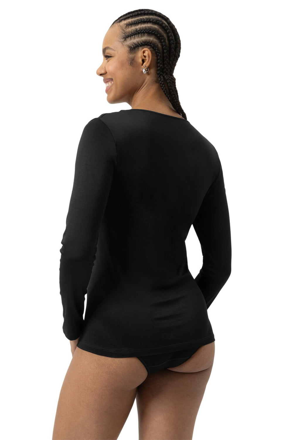 Person wearing a black long-sleeve bodysuit on a white background