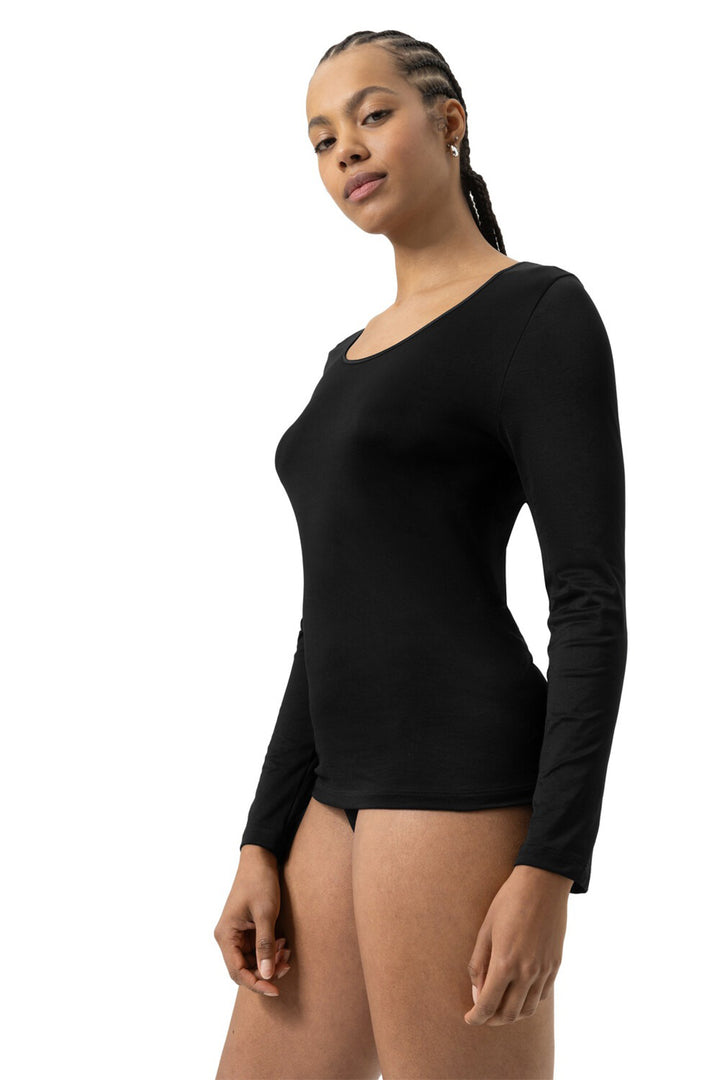 Woman wearing a black long-sleeve top on a white background