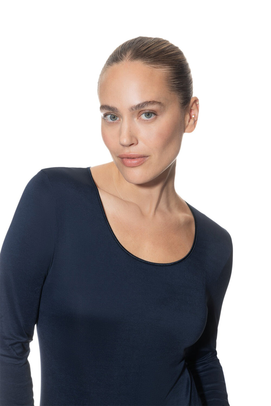 Woman wearing a black long-sleeve top against a white background