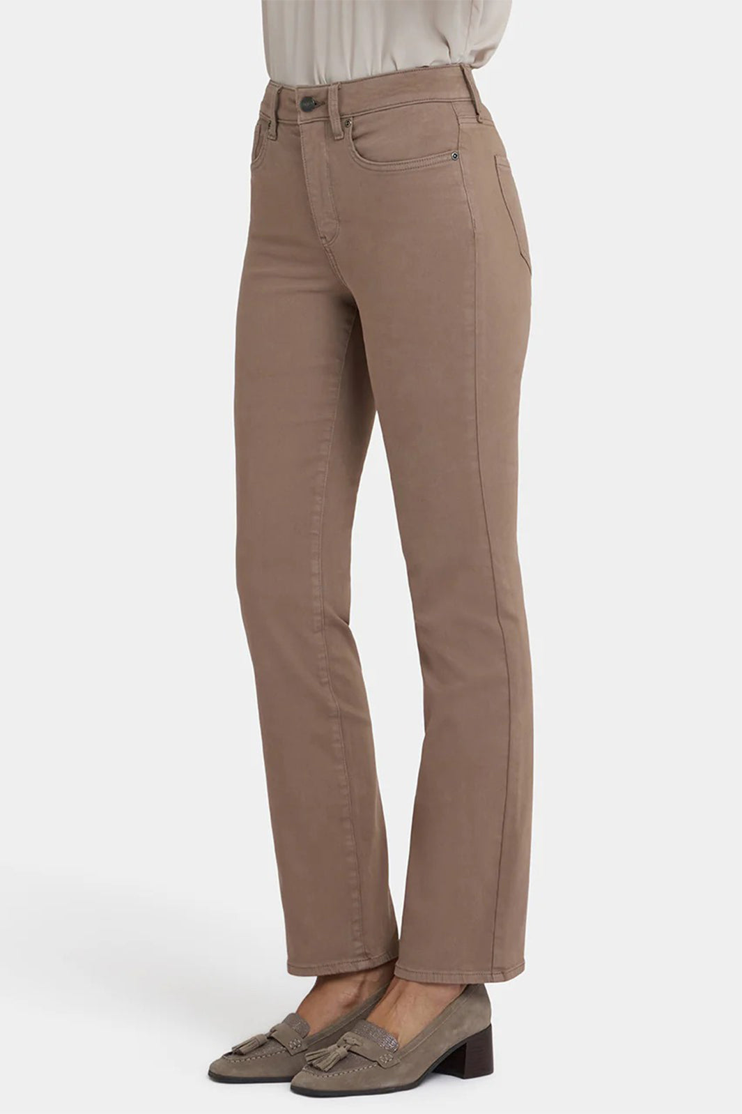 Beige pants worn with a white shirt on a white background