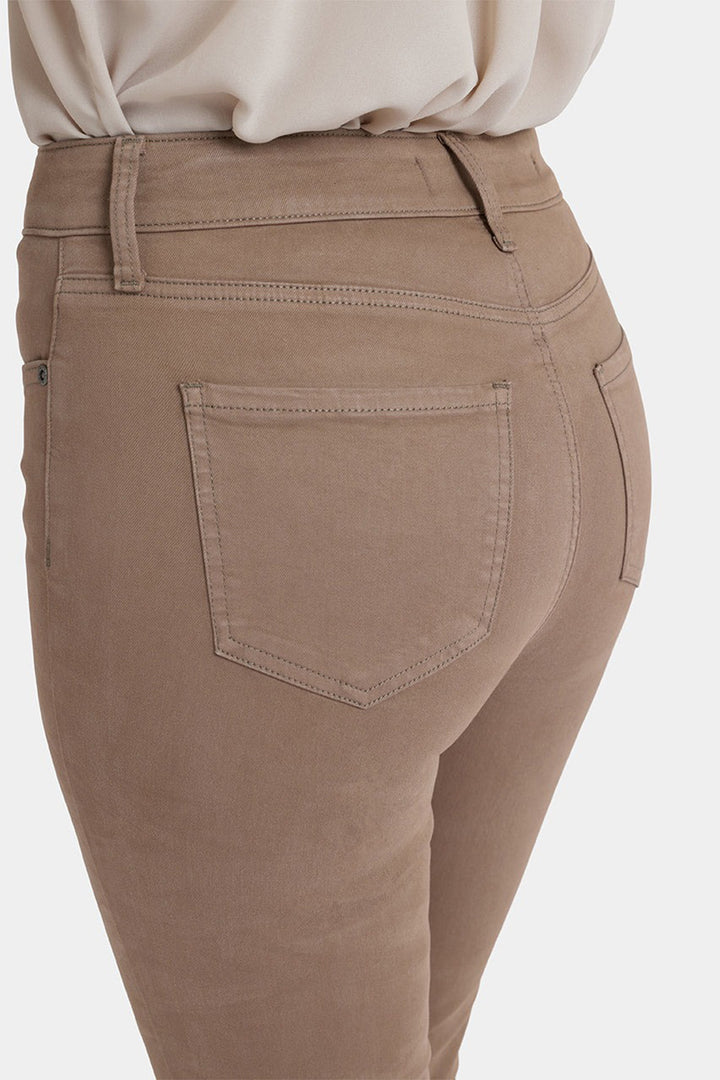 Brown pants with a pocket detail on a white background