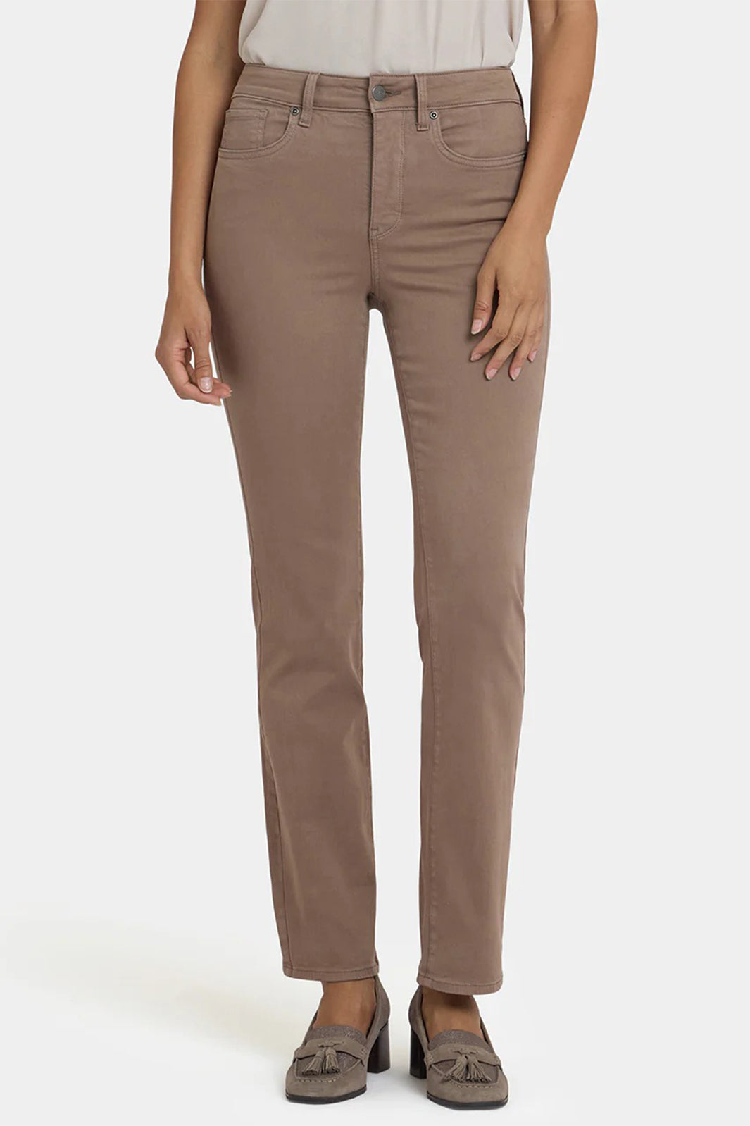 Brown pants worn by a person on a white background