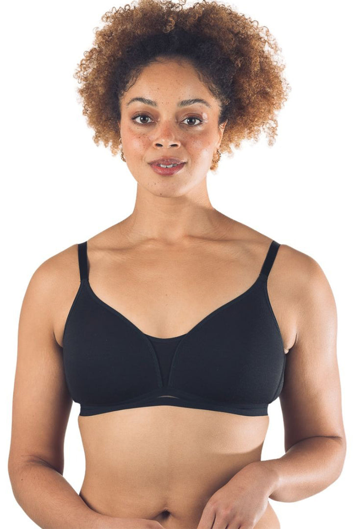 Woman wearing a black bra on a white background