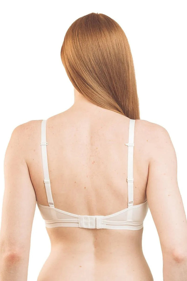 Woman wearing a beige bra on a white background