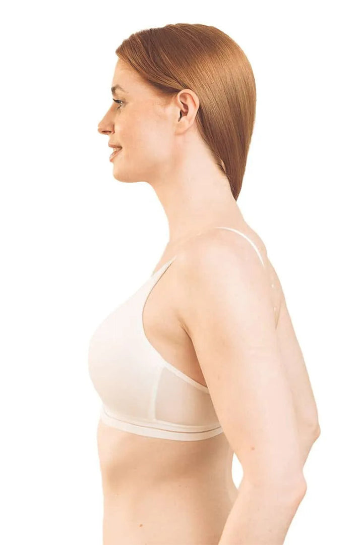 Woman wearing a beige bra on a white background