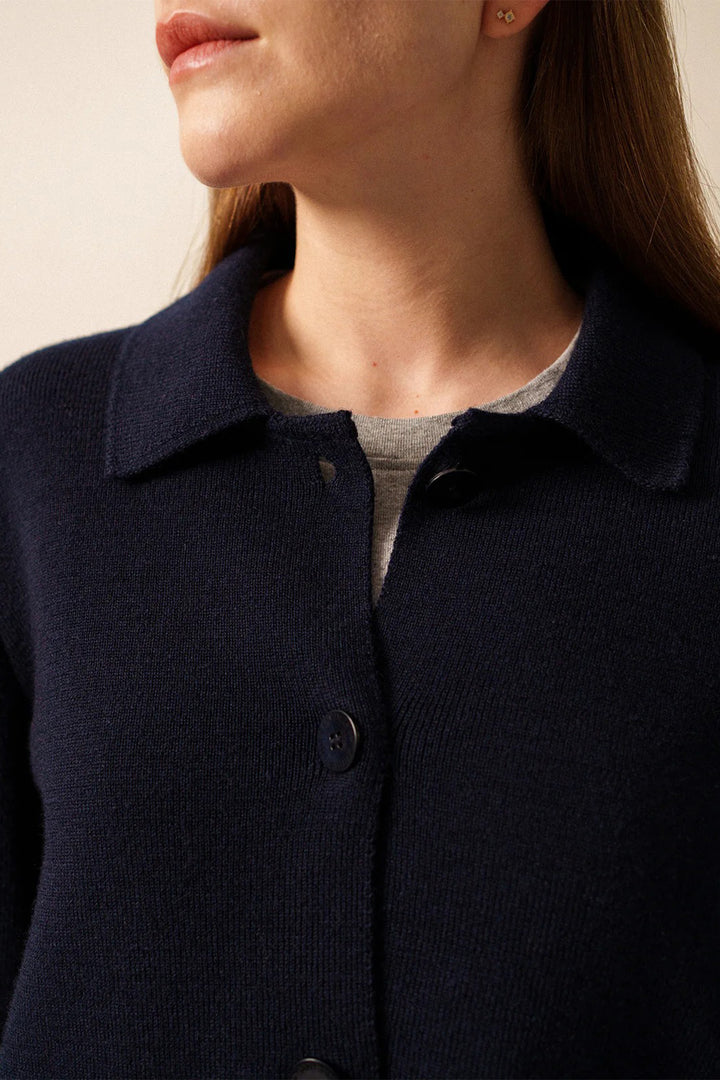 Navy blue button-up shirt worn by a person with a neutral background