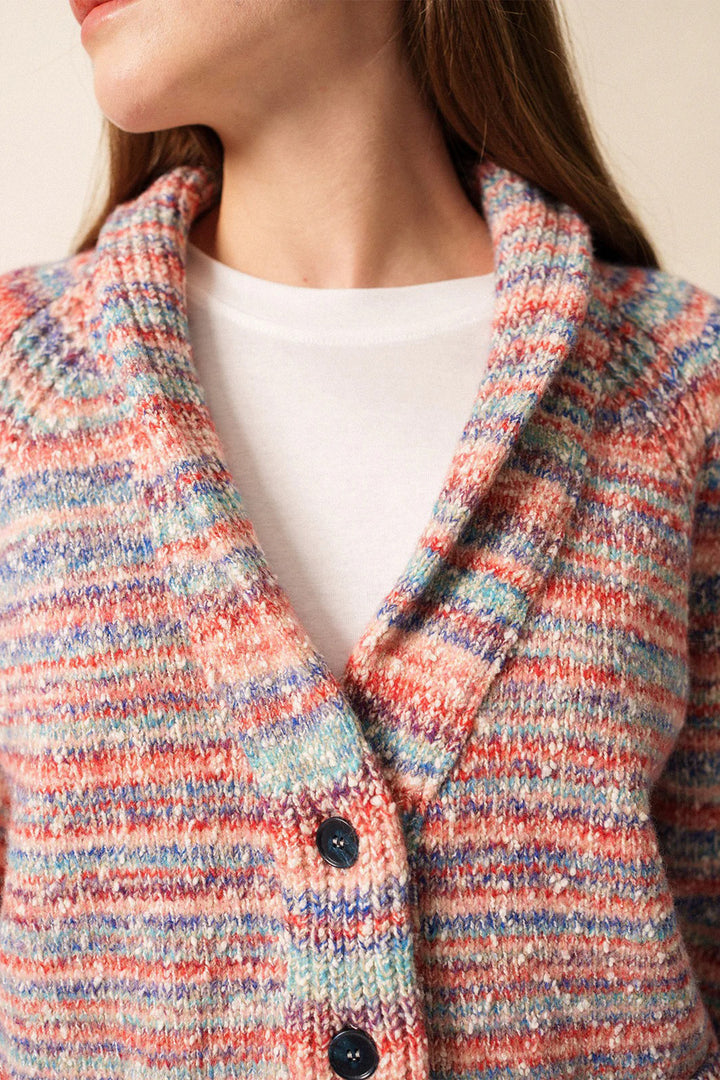 Close-up of a multicolored textured coat with a white shirt underneath.