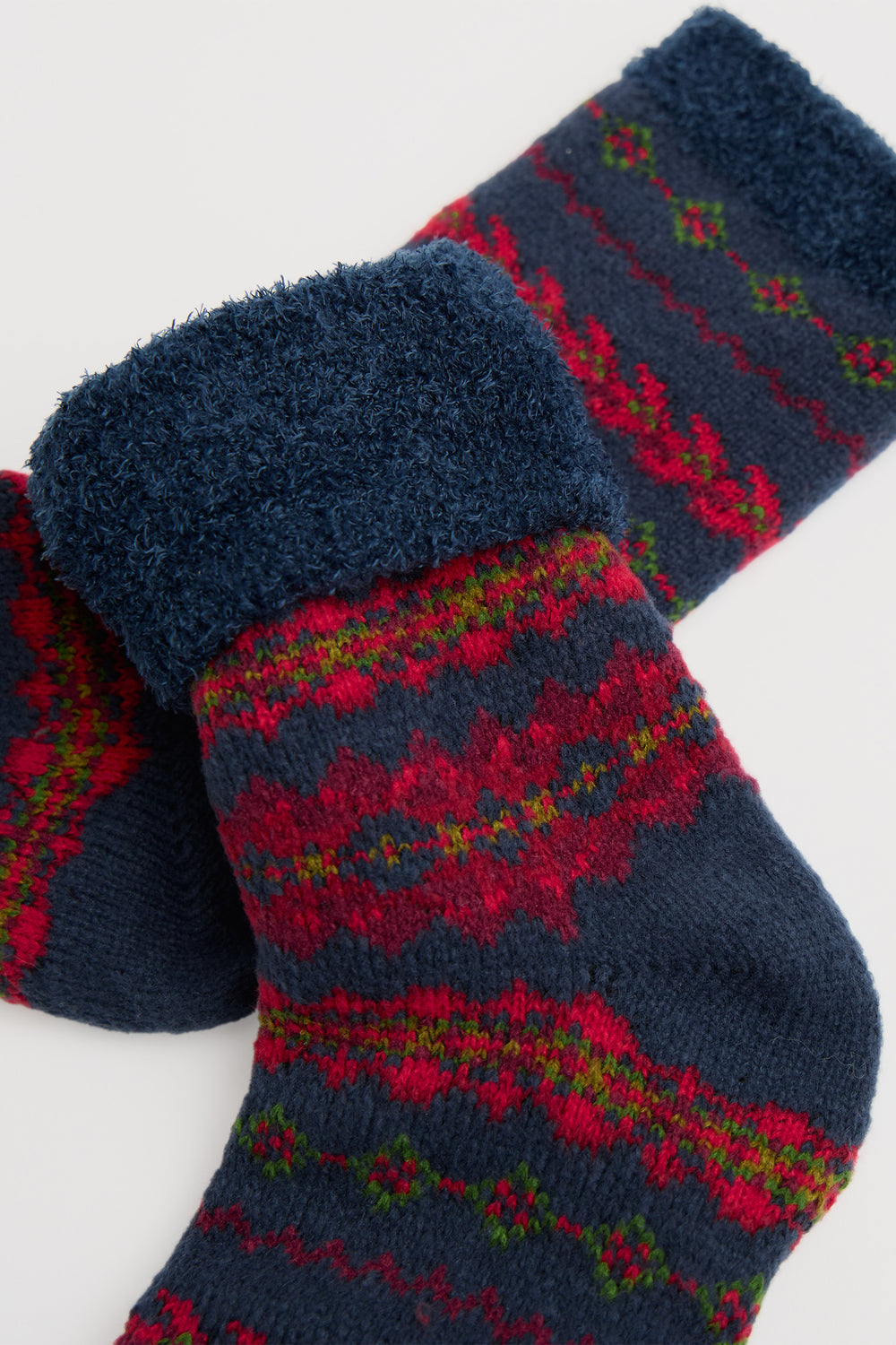 Pair of blue and red patterned socks on a white background