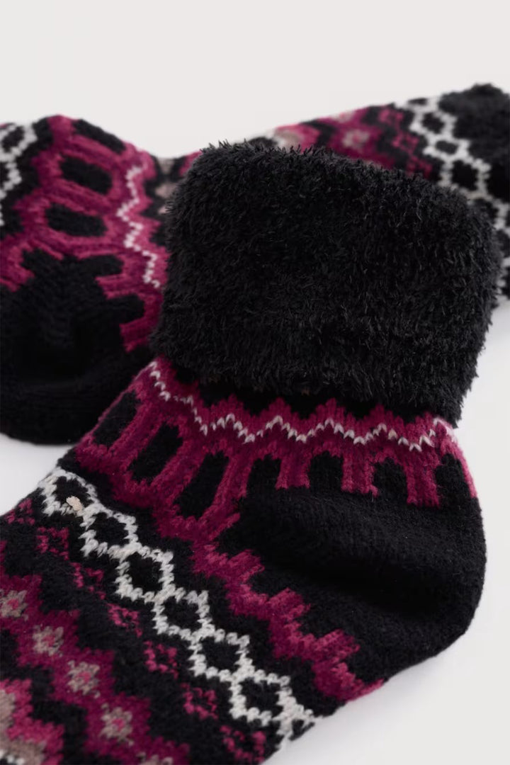 Pair of black socks with pink and white pattern on a white background