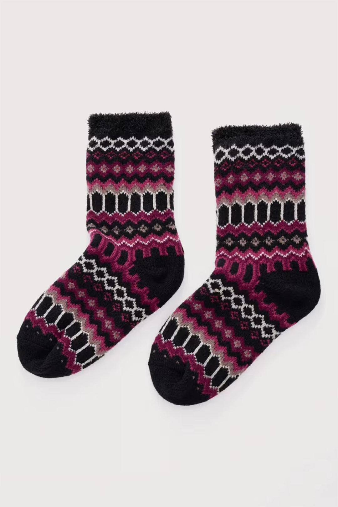 Pair of black and pink patterned socks on a white background