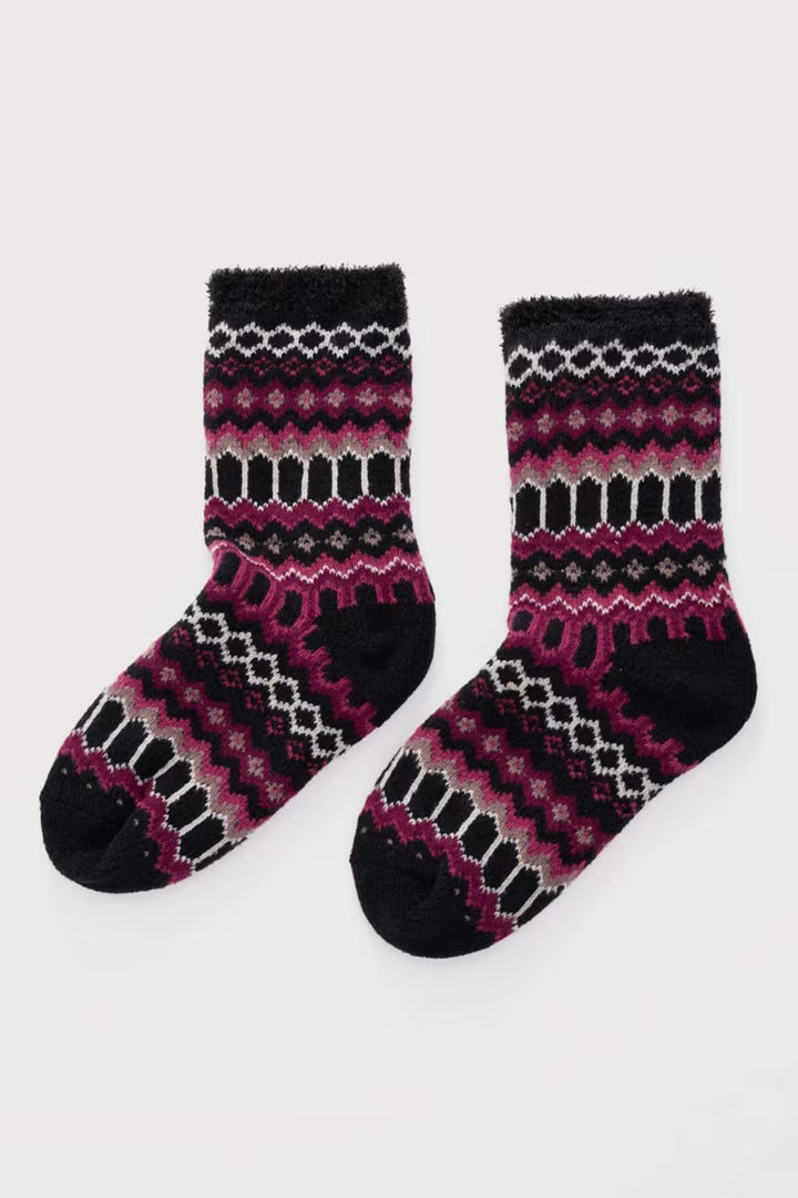 Pair of black and pink patterned socks on a white background