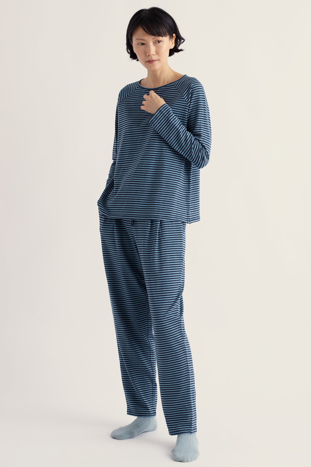 Seasalt Cornwall Setting Sun Obliques Maritime Cadet Navy Pyjamas, full length on model