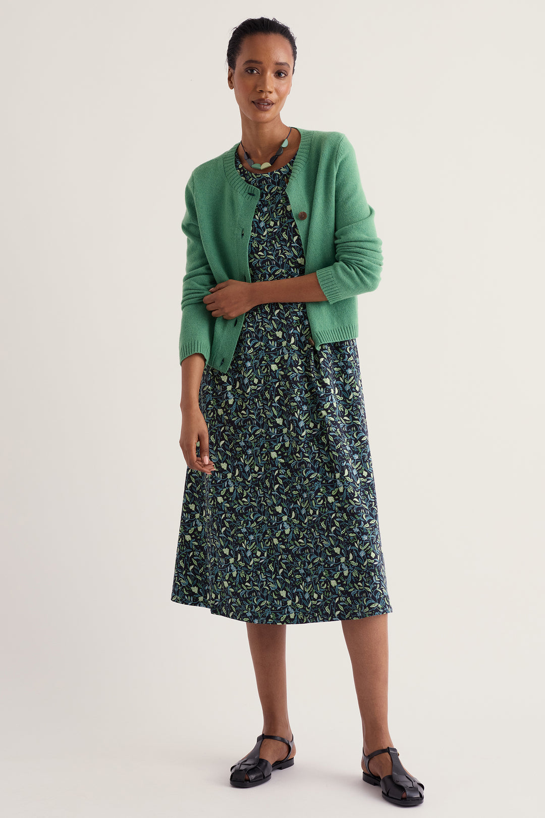 Seasalt Cornwall Veronica Garden Peas Maritime Navy Dress WM32710 38406, worn with a green cardigan
