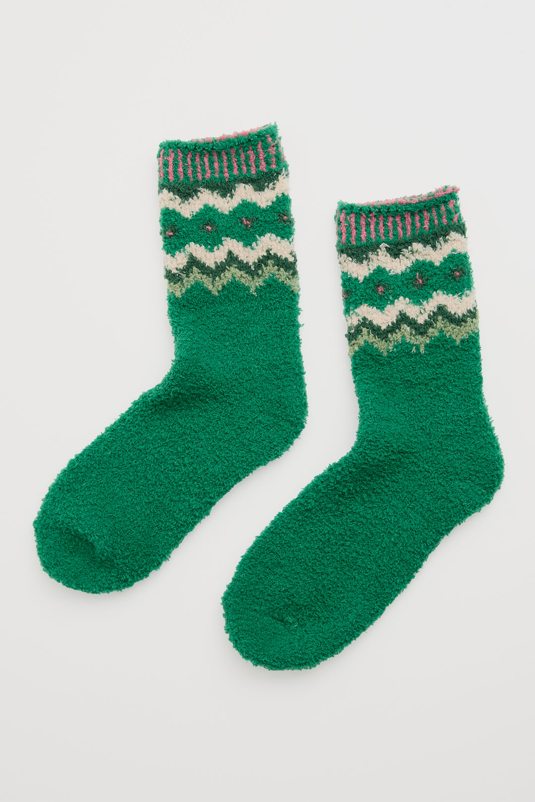 Pair of green socks with patterned cuffs on a white background