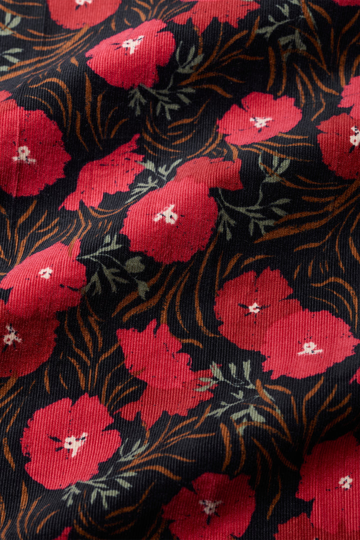 Close-up of fabric with red floral pattern on black background