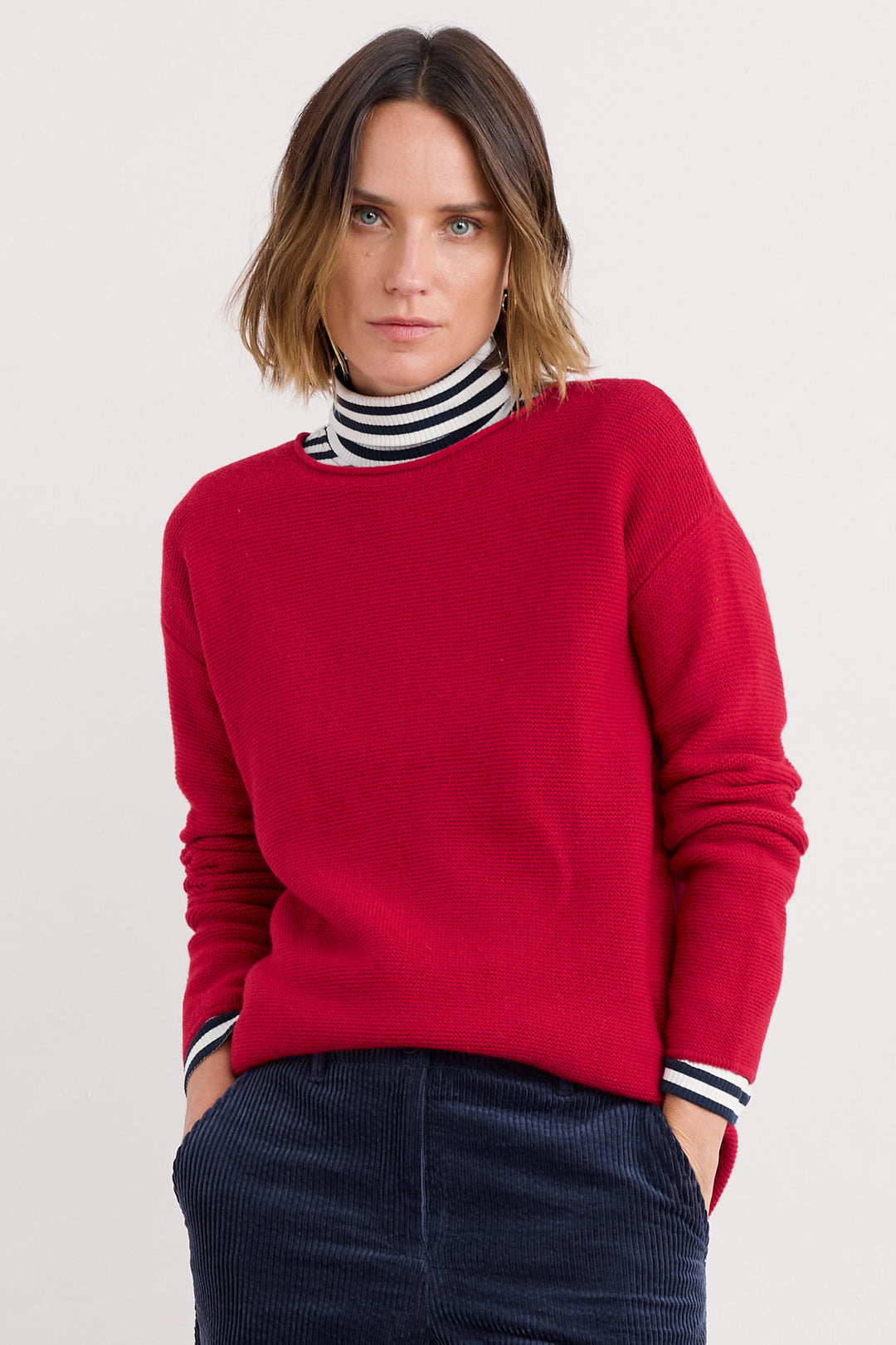 Person wearing a red sweater with a white background