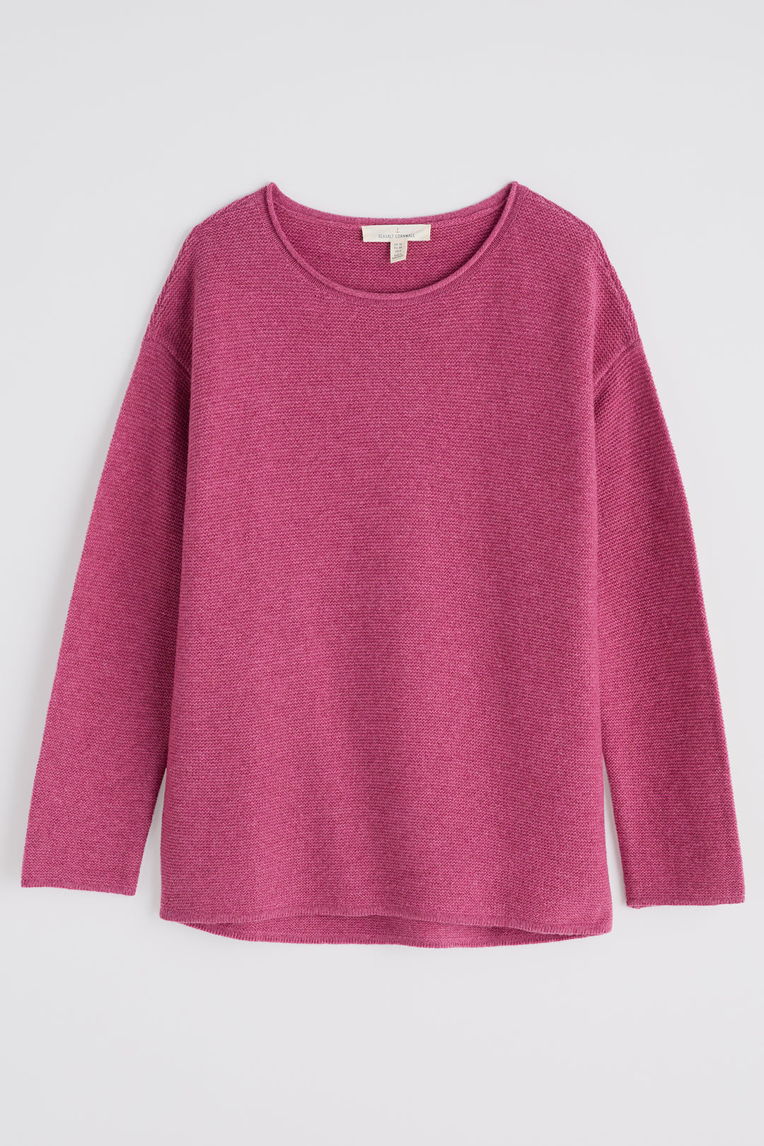 Pink sweater on a light gray background