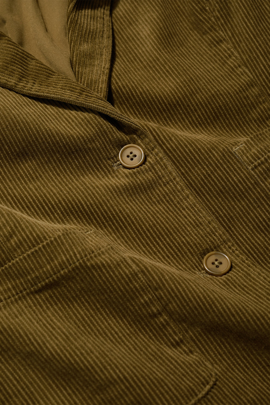 Close-up of a brown corduroy shirt with buttons