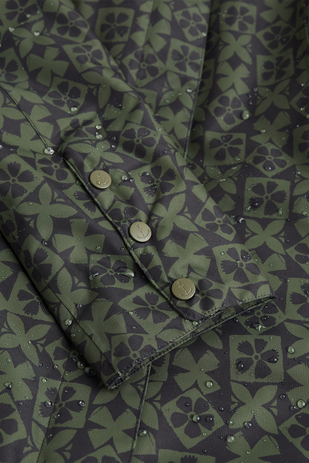 Close-up of a green patterned fabric with buttons