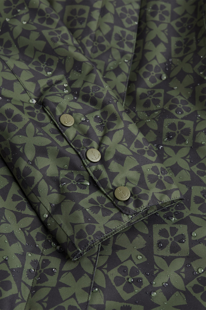 Close-up of a green patterned fabric with buttons