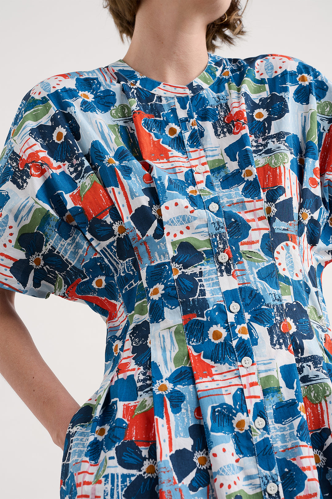Close-up of a colorful floral dress with a white background