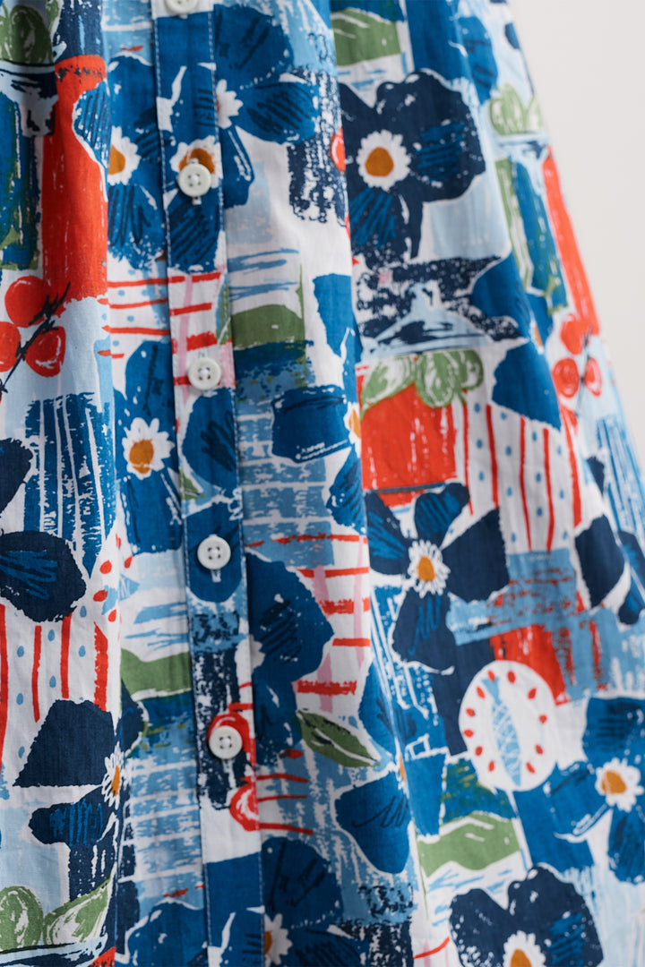 Close-up of a colorful fabric with floral and abstract patterns.