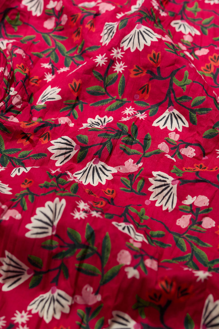 Floral patterned fabric with white flowers on a red background
