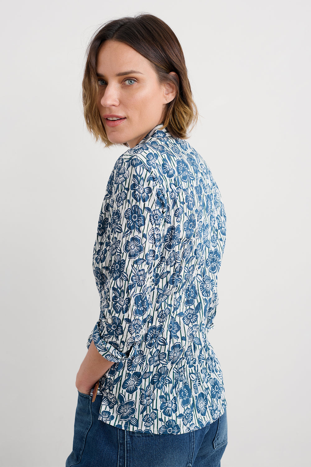 Woman wearing a blue floral blouse on a white background