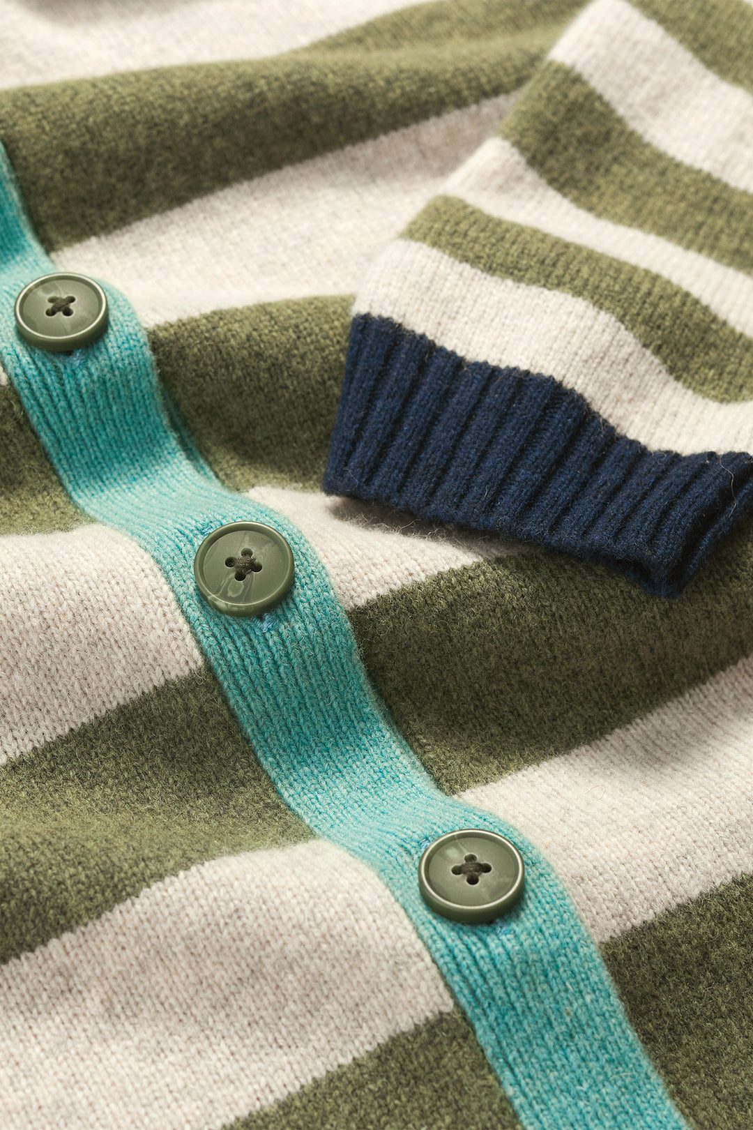 Close-up of a striped sweater with buttons and ribbed trim