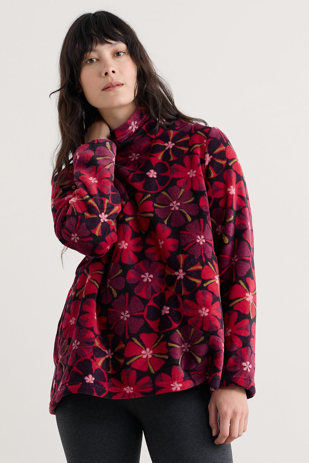 Person wearing a red floral patterned jacket on a white background