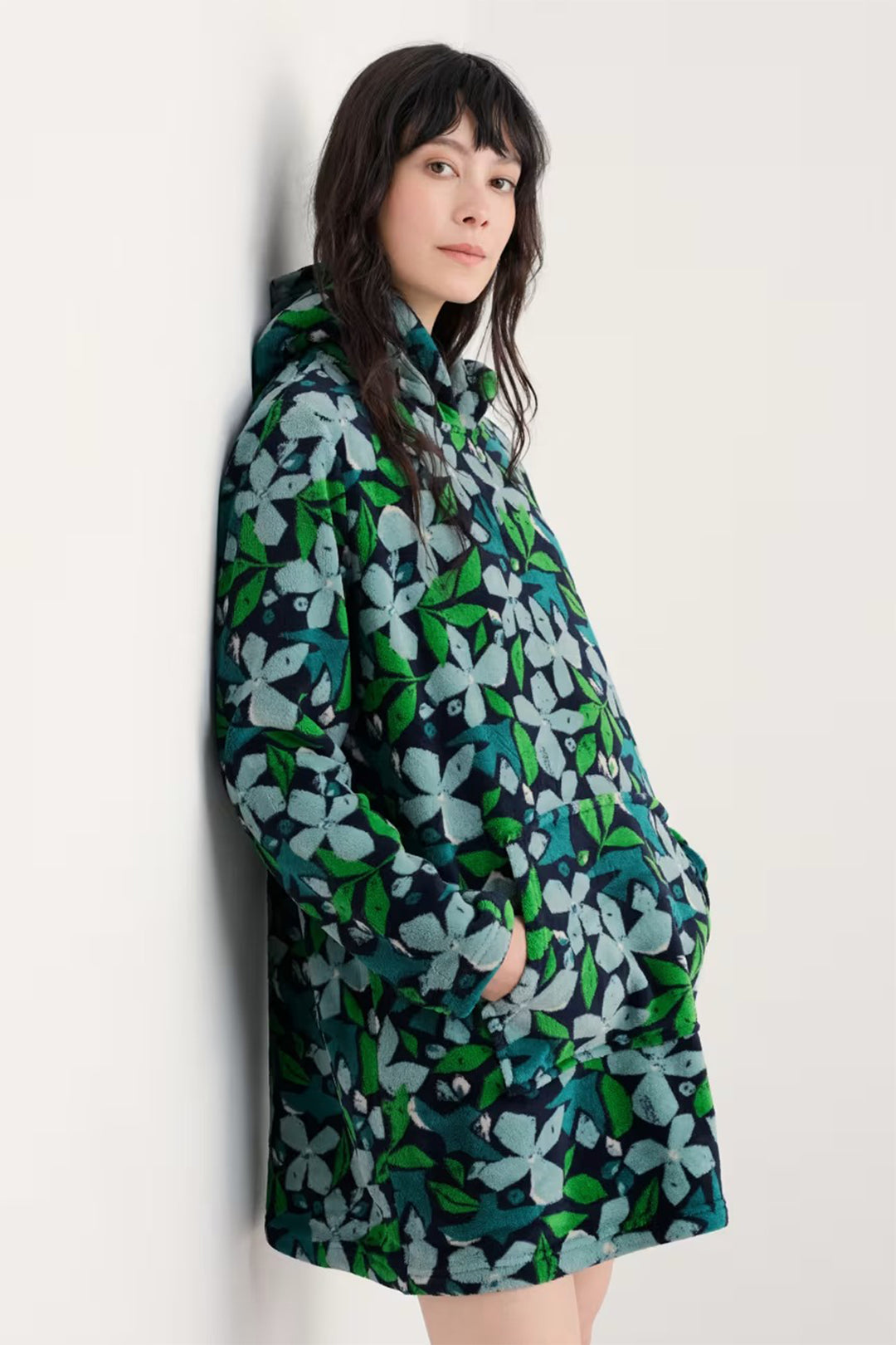 Person wearing a floral patterned dress against a white background