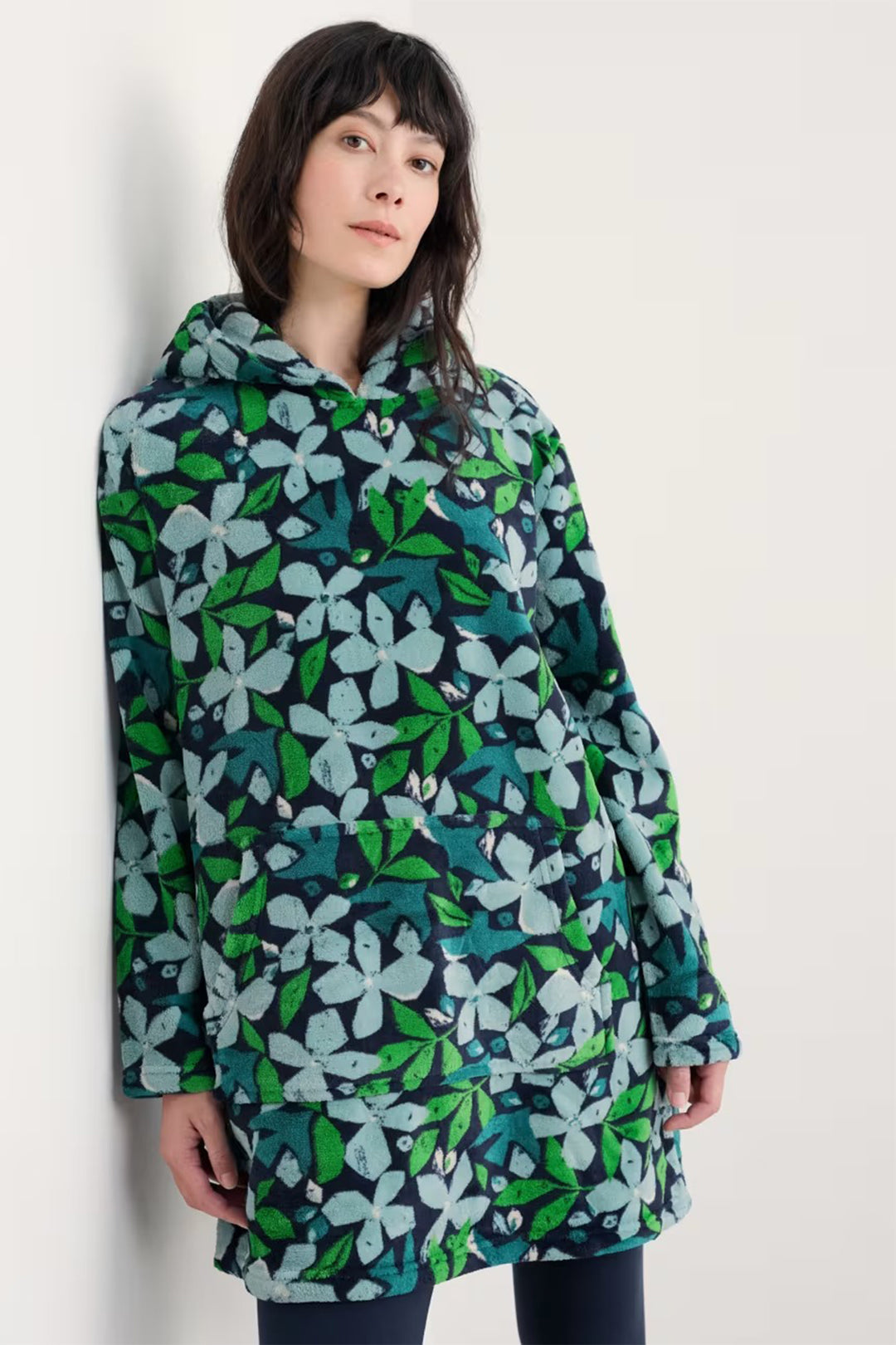 Woman wearing a floral patterned jacket against a white background