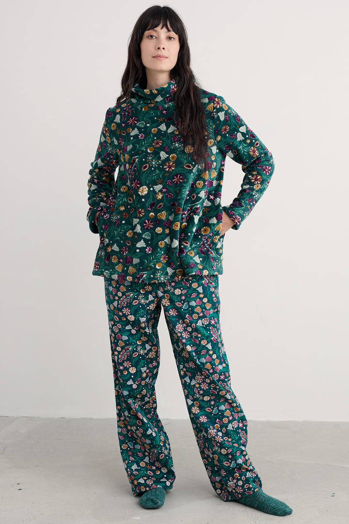 Person wearing a floral pajama set on a white background