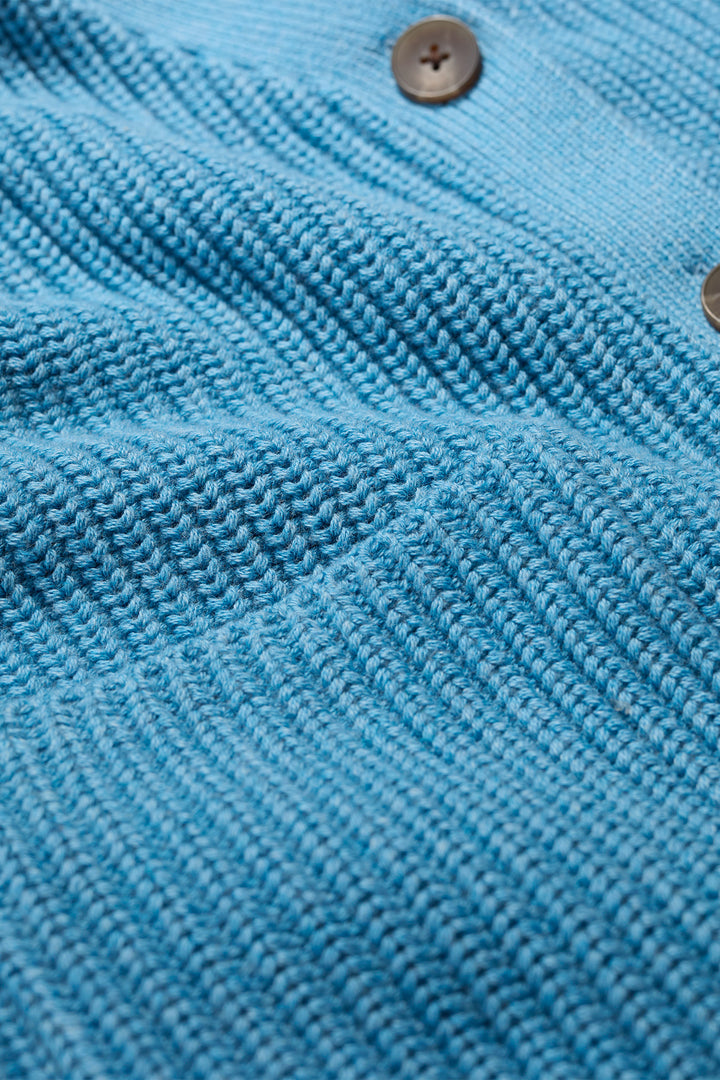 Close-up of blue textured fabric with a button