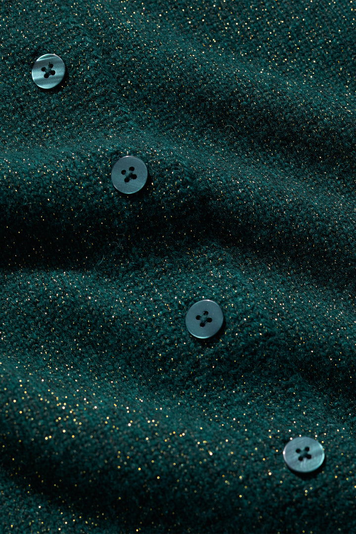Close-up of dark green fabric with buttons on a textured background