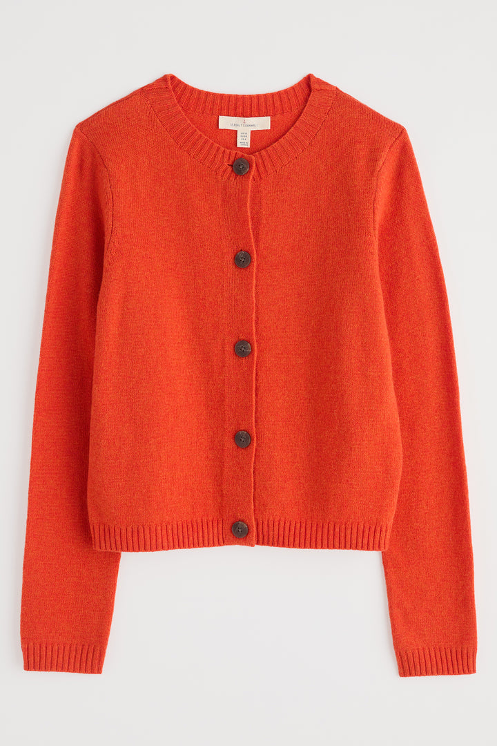 Orange cardigan with black buttons on a light gray background