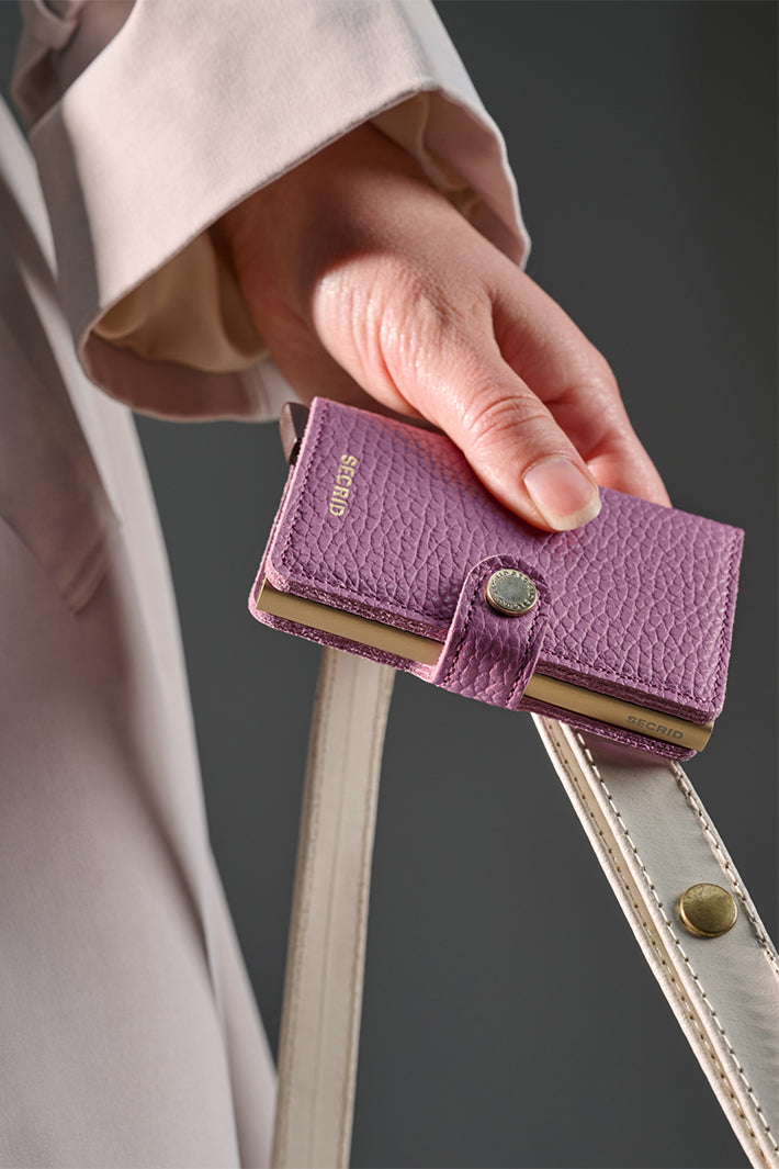 Secrid Miniwallet Pebble Orchid Purple, held in hand