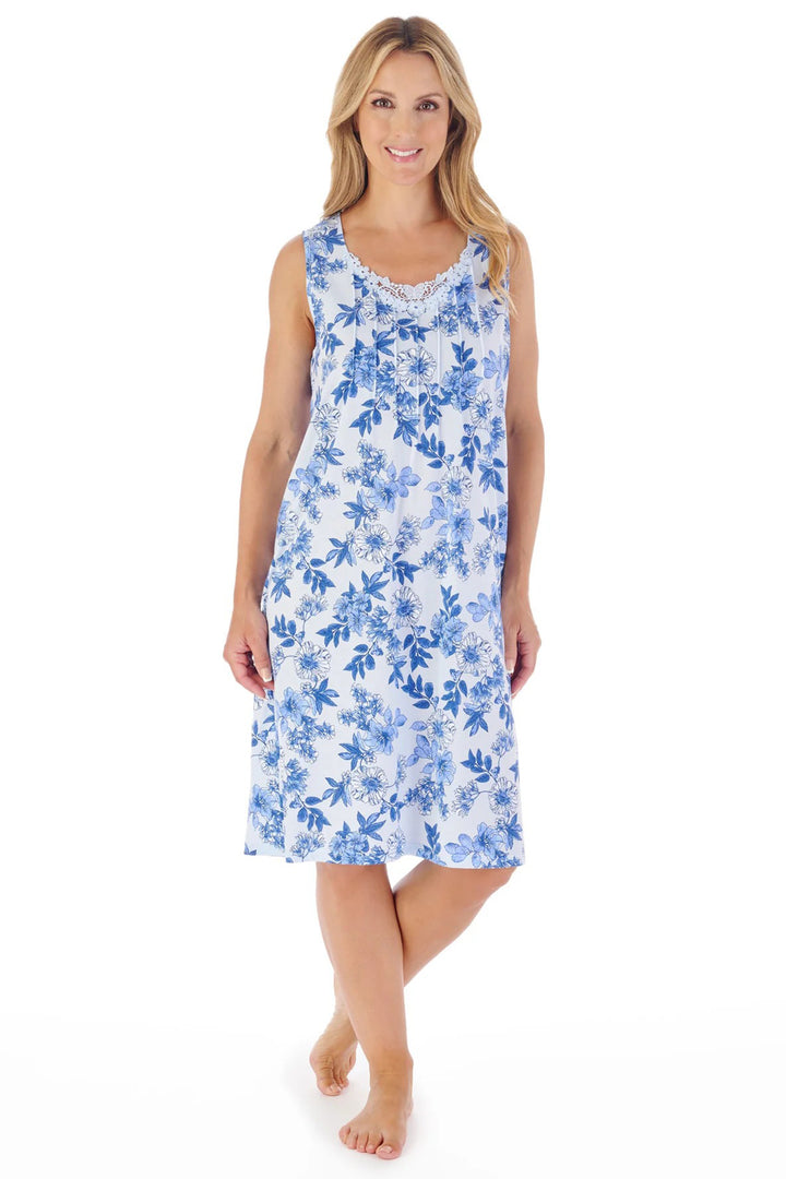 Woman wearing a blue floral nightgown on a white background