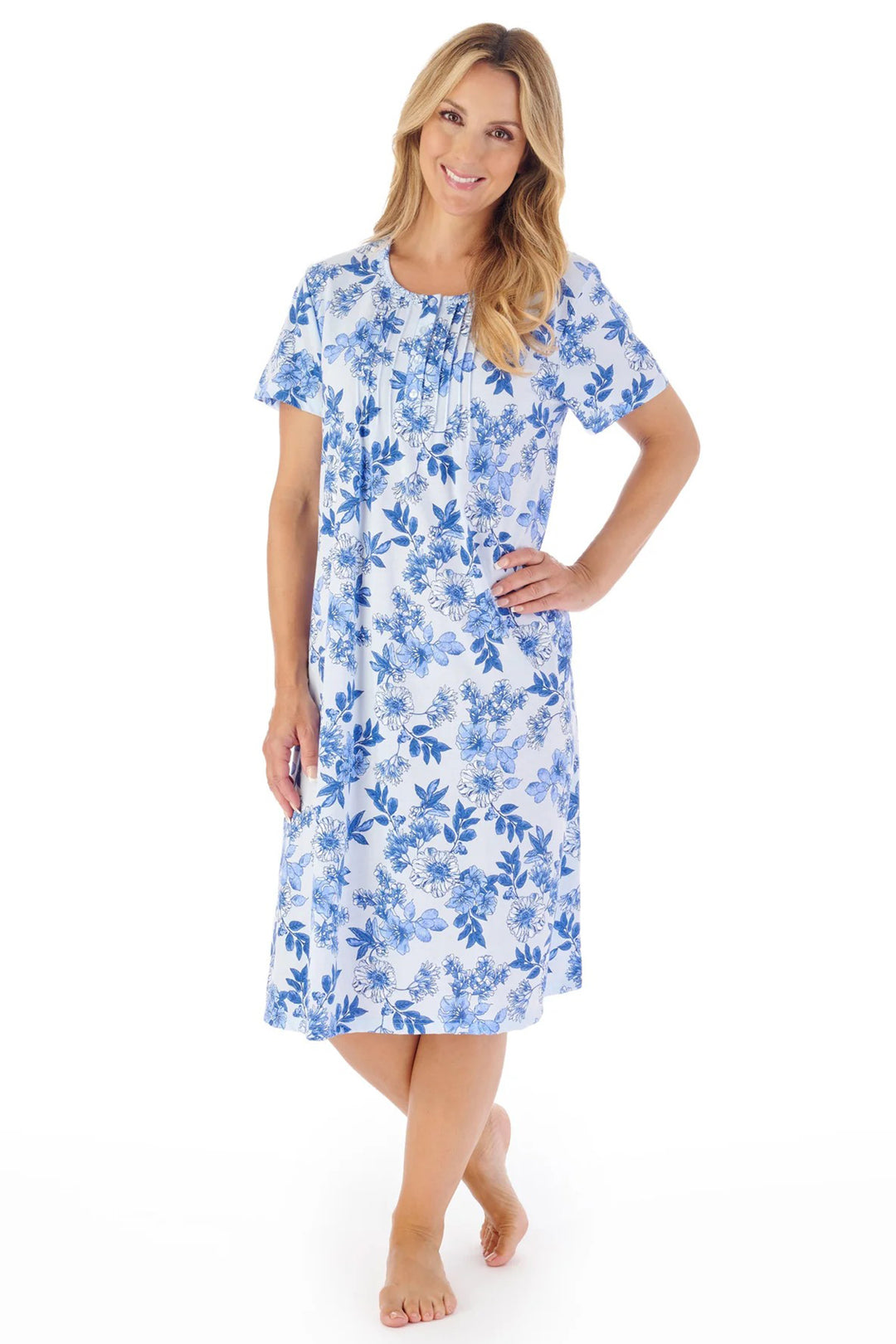 Woman wearing a blue floral nightgown on a white background