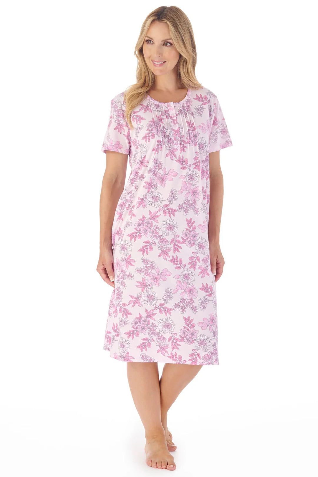 Woman wearing a pink floral nightgown on a white background