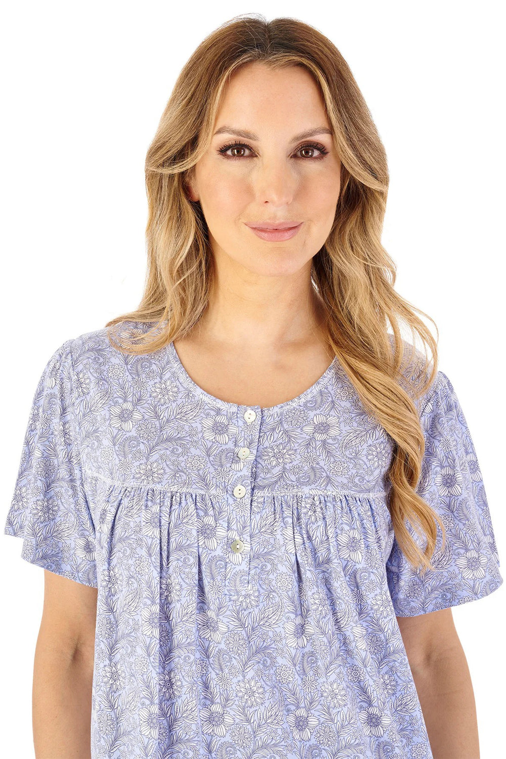 Woman wearing a blue floral patterned blouse on a white background