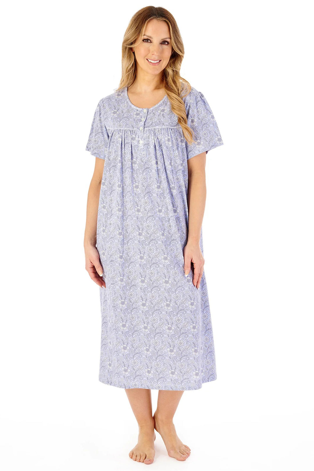 Woman wearing a long floral nightgown on a white background