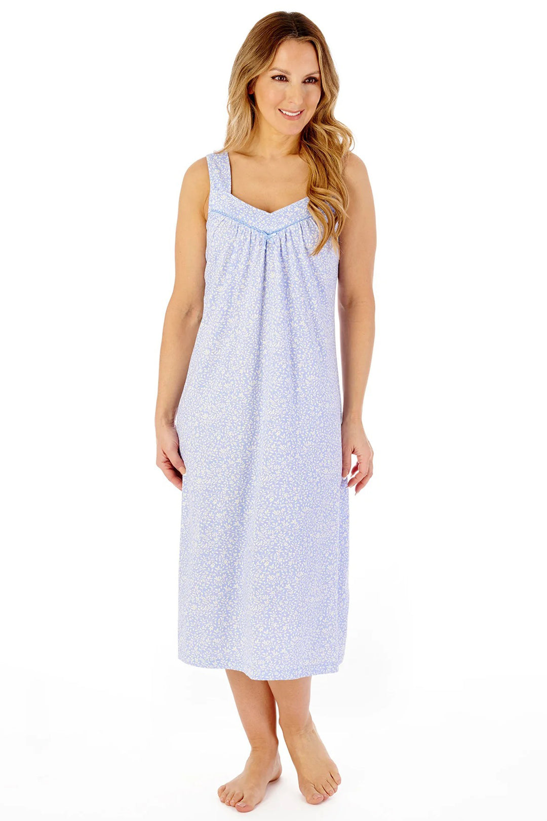 Woman wearing a light blue patterned nightgown on a white background