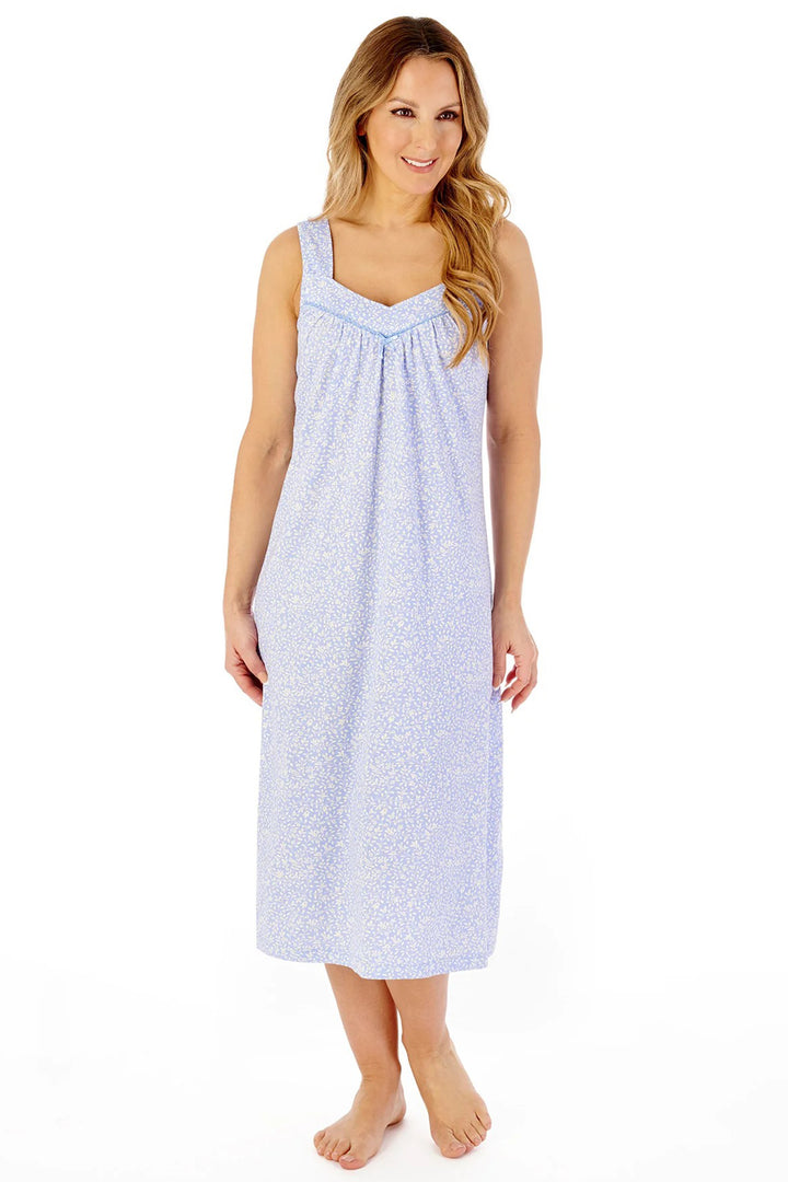 Woman wearing a light blue patterned nightgown on a white background
