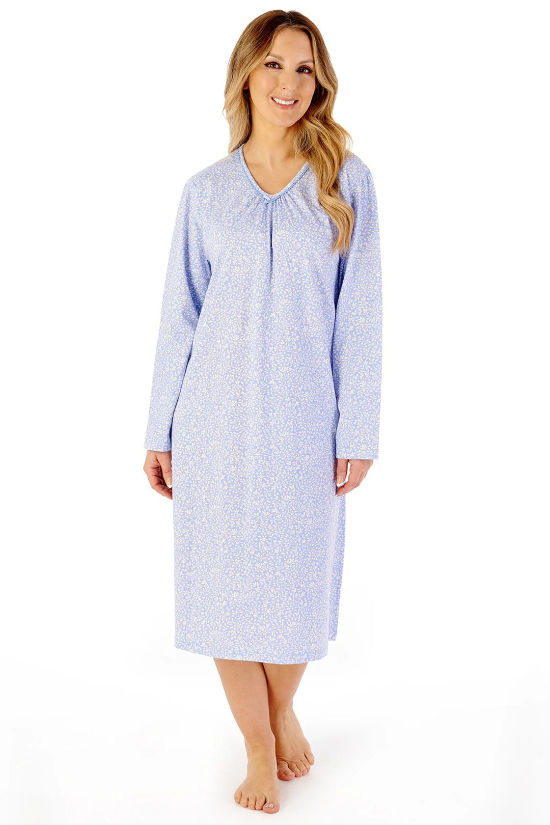 Woman wearing a blue patterned nightgown on a white background