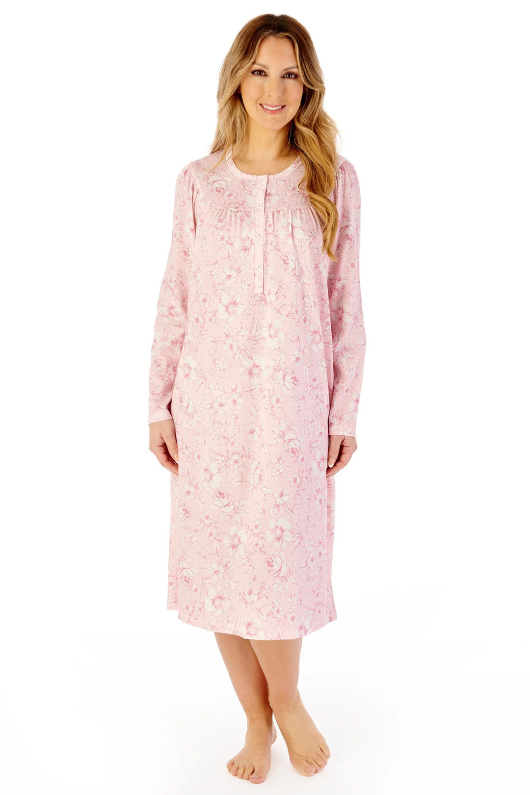 Woman wearing a pink floral nightgown on a white background
