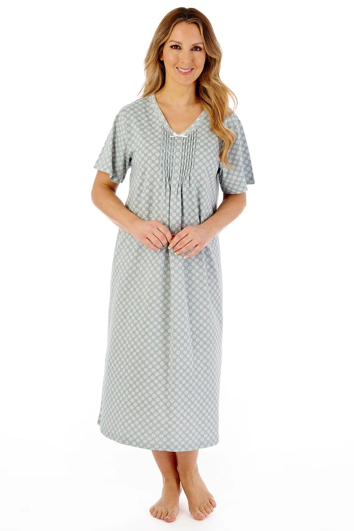 Woman wearing a gray patterned nightgown on a white background