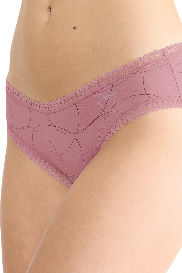 Pink lace underwear being worn on a white background