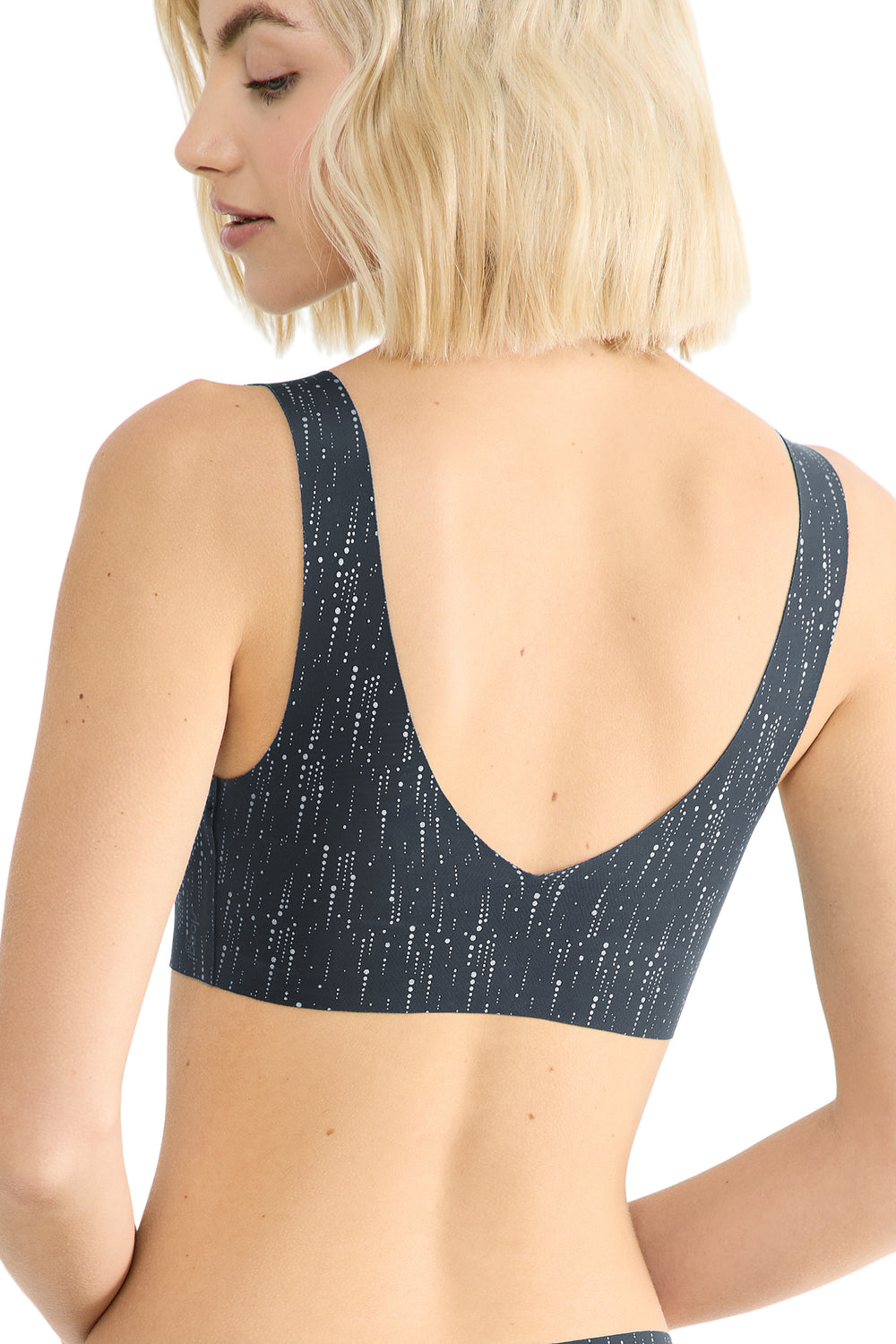 Person wearing a black bralette on a white background