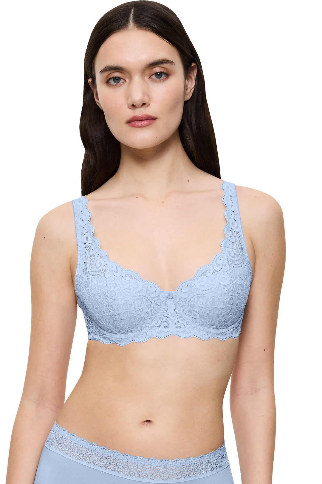 Woman wearing a light blue lace bralette on a white background